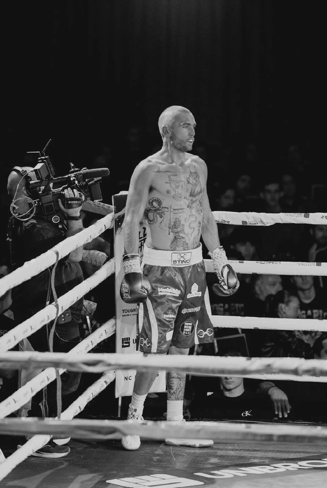 Campbell Somerville standing in the ring under the lights after a professional bout.